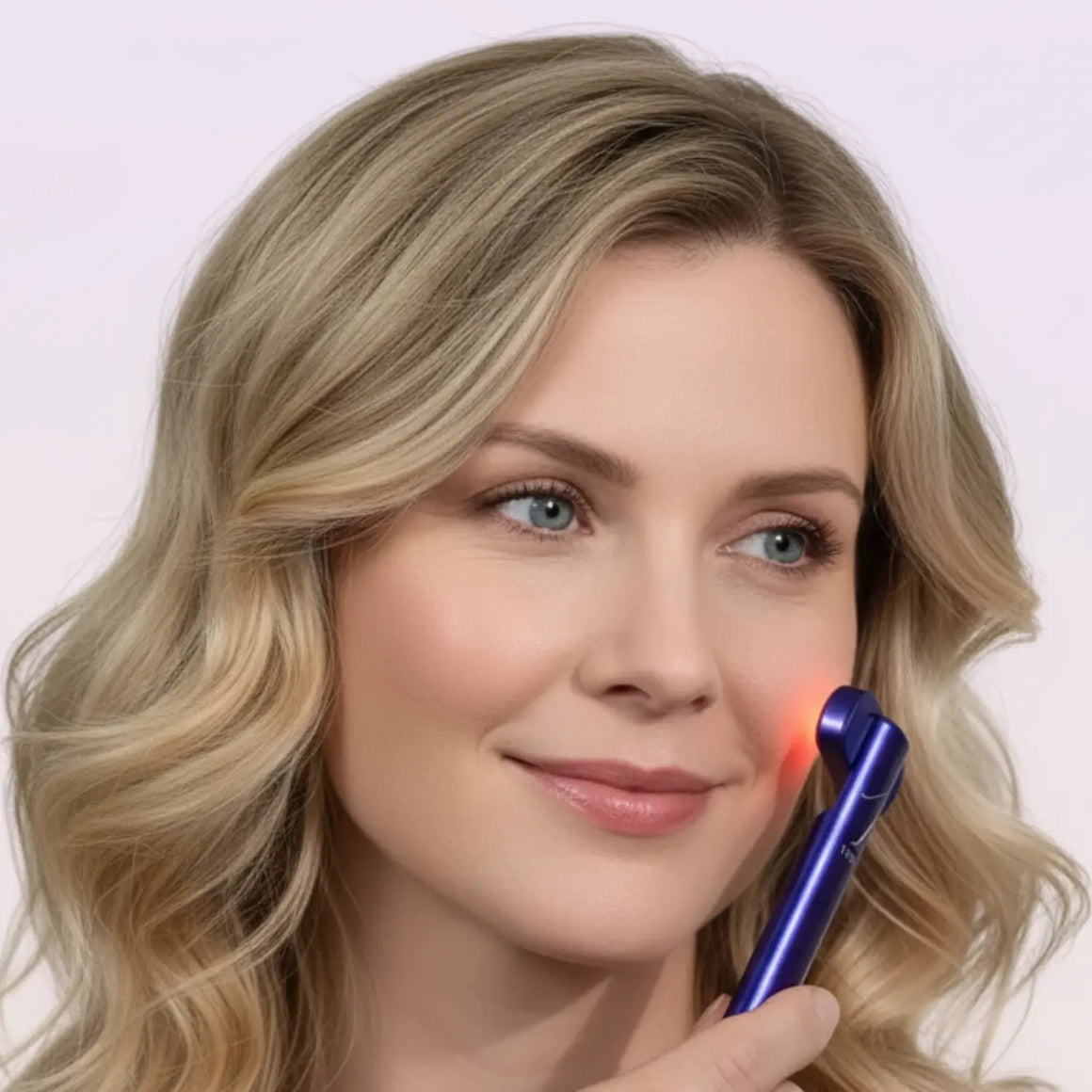 Blonde-woman-using-purple-Chromaglow-wand-with-glowing-red-light-treatment-on-her-cheek