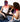 Two women relaxing on a couch, one wearing the Equinox Pro LED face mask and one using a red light neck and chest wrap